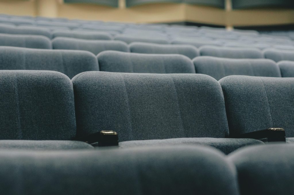 Close-up view of empty auditorium seats, perfect for conference or event themes.